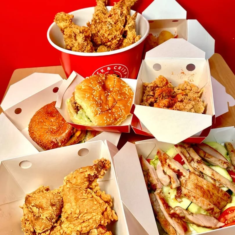 Cluck & Crispy Chicken's fried chicken bucket, sandwiches, chicken bites, and grilled chicken salad.
